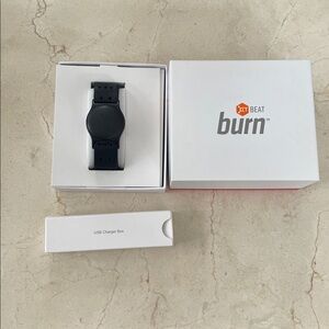 Orange Theory Beat Burn Heart rate monitor. Includes charging cord.
